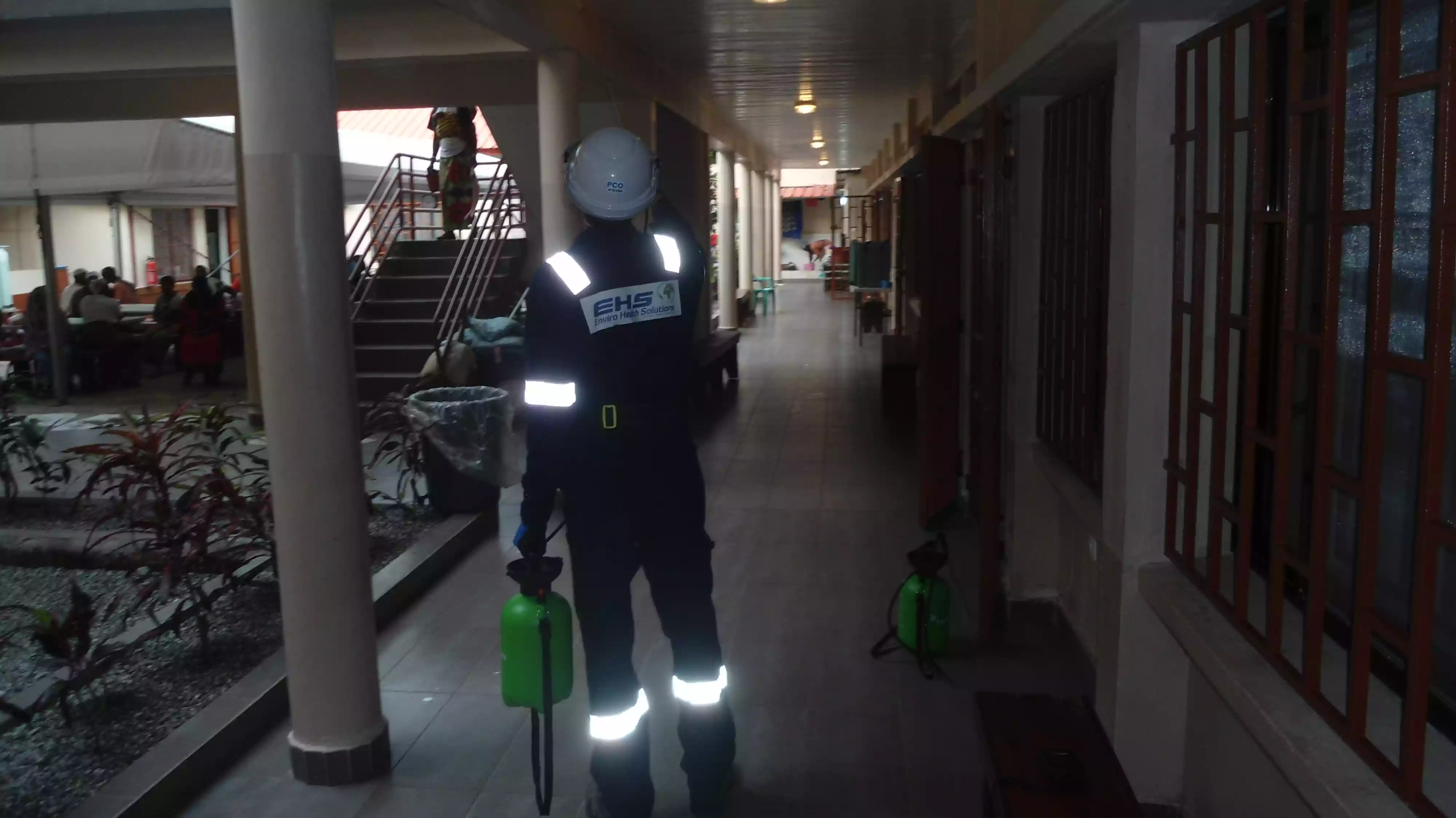 EHS worker walking with pesticide